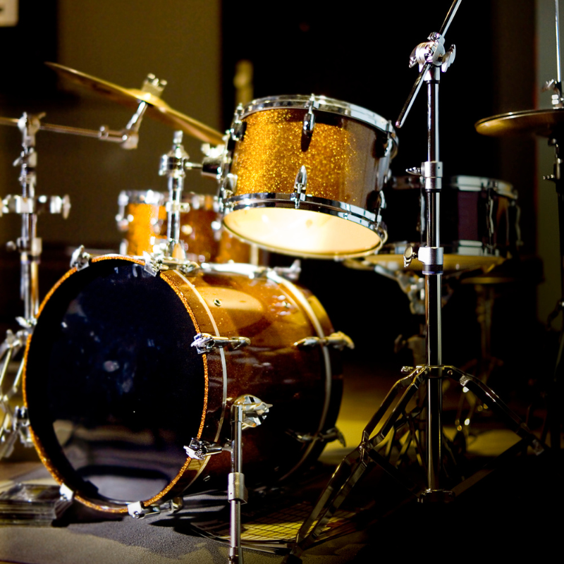 Close-up of a drum set with a focus on the drums and cymbals.